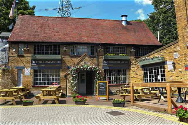 The Coach House pub exterior with bench seating, ideal for casual networking and team-building.