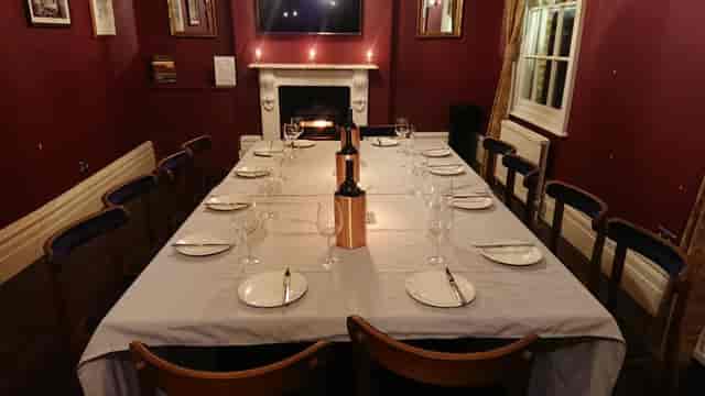 Private dining room with fireplace for corporate meetings and celebratory dinners.