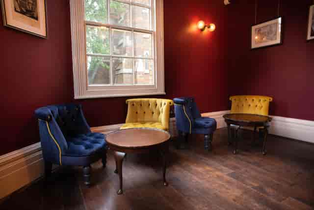 Private breakout room with tufted lounge seating for intimate corporate meetings and events.