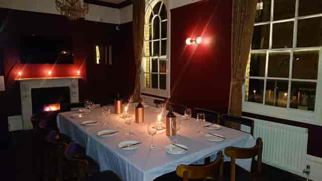 Private dining room at The Stonemasons Arms with fireplace for corporate events and receptions.