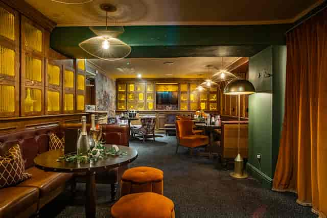 The Barnt Green Inn private dining room with cozy banquette seating for luxury networking events.