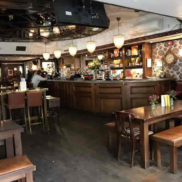 Main Restaurant pub venue with communal dining tables for networking events and team building.