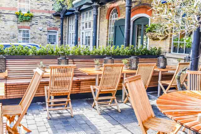 Outdoor breakout space with bench seating, ideal for networking events and corporate lunch hire.