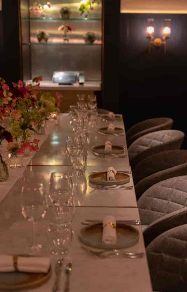 Upscale private dining room at Strand Palace with quilted chairs for exclusive board dinners.