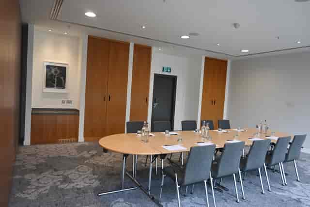 Meeting Room 7 boardroom with neutral decor for corporate offsites and strategy sessions.