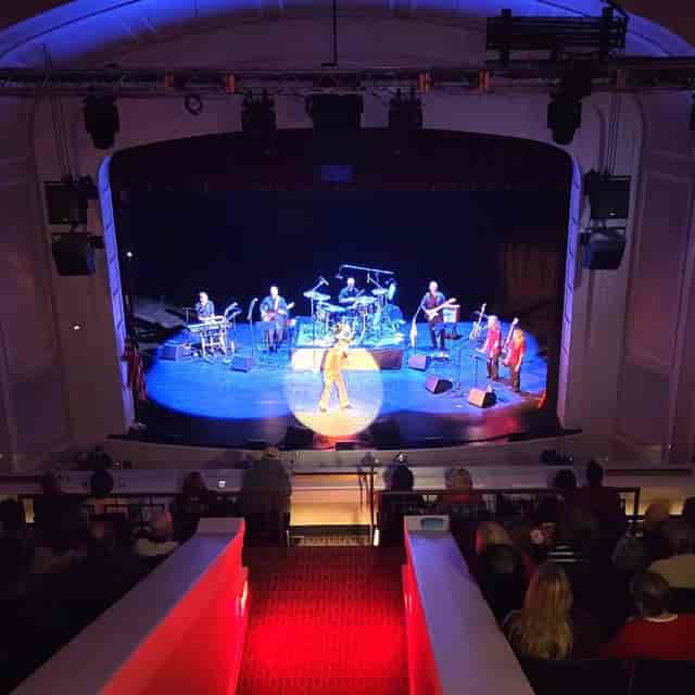 Proscenium theatre stage with spotlight for keynote performance and plenary session.