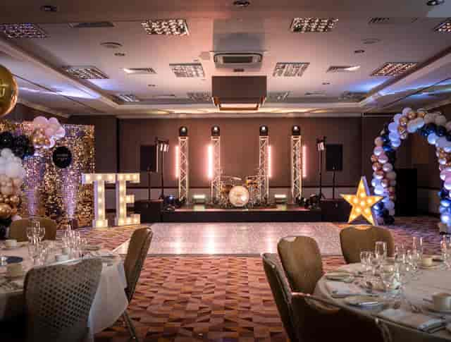 Amrita Hall ballroom with stage and dance floor for wedding or corporate event.
