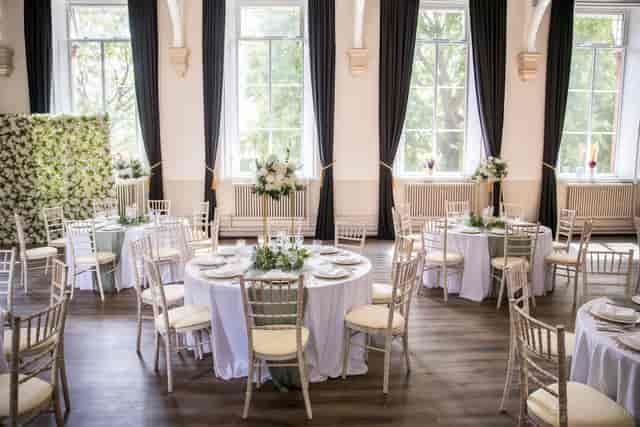 Main Hall ballroom with sage accents, elegant seating for weddings and gala events.