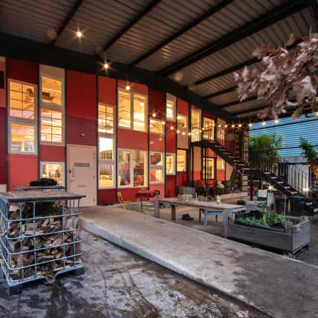 Industrial-chic Paper Garden venue with large Jarrah tree for networking events and workshops.