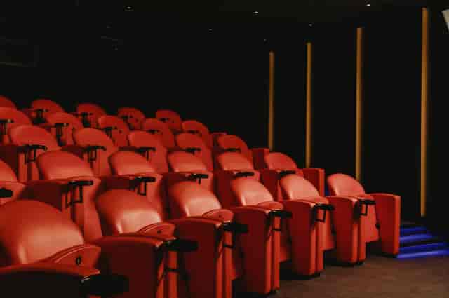 Tiered screening room with tablet arms for corporate presentations and private events.