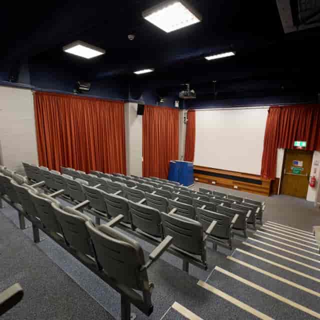 Clifton Suite auditorium with red curtains for film screenings and lectures.