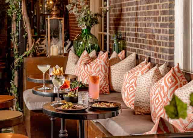 Networking lounge at The Cardinal Bar & Kitchen featuring industrial-chic banquette seating.