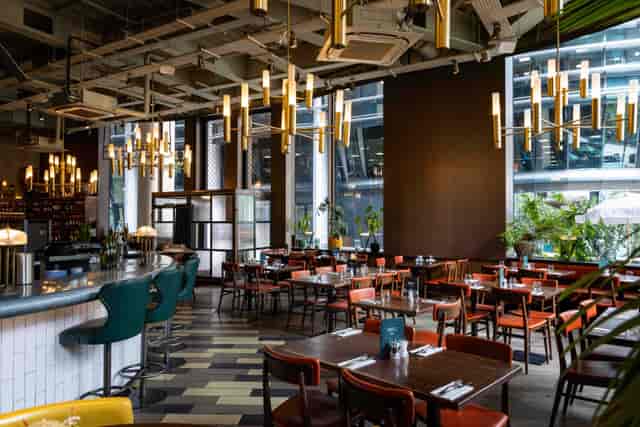 Industrial-chic restaurant venue with bar seating for corporate mixers and networking dinners.