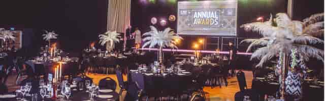 Art Deco awards gala at O2 Academy2 Islington with feather centerpieces and branded stage.