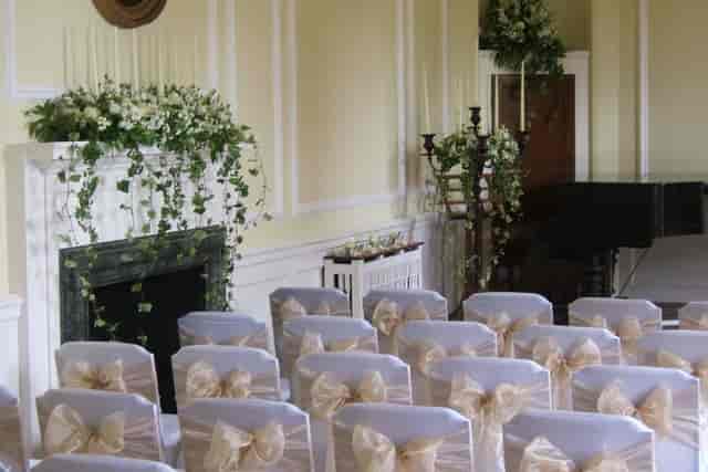 Georgian Music Room ceremony with floral decor, grand piano, and luxury wedding venue setup.