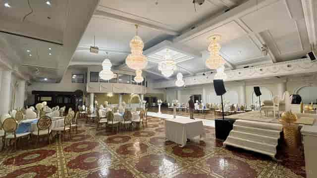 Amrita Hall Main Hall ballroom with tiered stage seating for formal events and ceremonies.