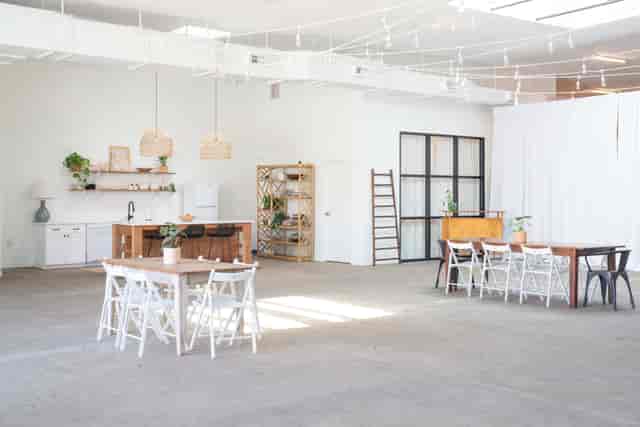 Industrial-chic Front Lounge event venue with bistro lighting for workshops and social mixers.