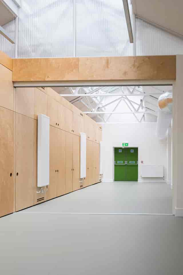Modern wood-paneled Community Hall event venue for workshops and breakout sessions.