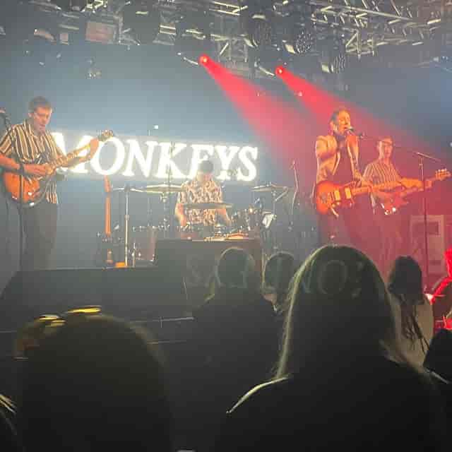 Live performance at The Liquid Room featuring branded signage and dramatic concert lighting.