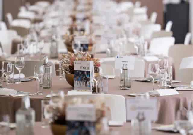 Modern corporate gala setup with branded banquet tables at The Liquid Room venue.