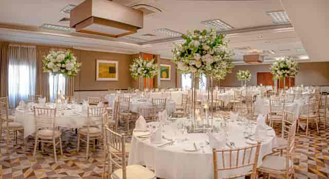 Ballroom wedding gala venue at The Liquid Room with elegant high-rise floral centerpieces.