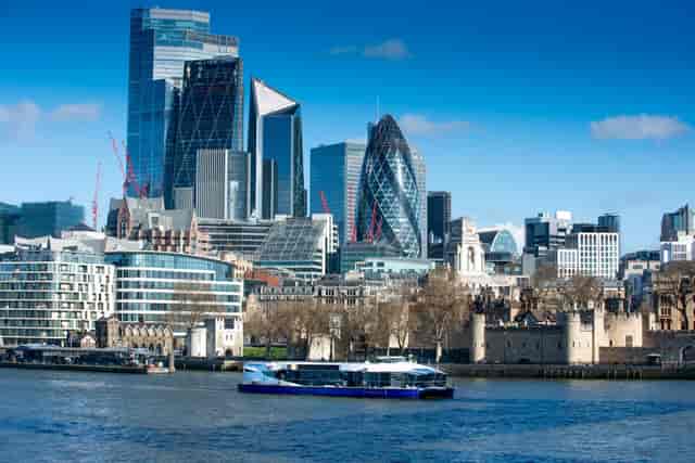 Golden Star boat on River Thames, London skyline, corporate event hospitality and river cruise.