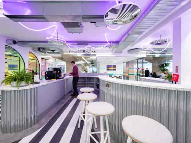 Modern breakout space with industrial decor for networking events and corporate meetings.