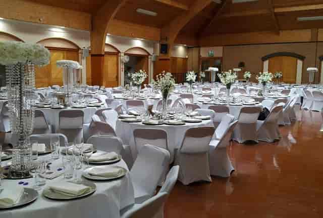 Main Hall banquet setup with white linens for wedding reception or corporate event venue.
