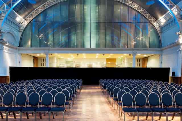 Lindley Hall plenary setup with pipe-and-drape for corporate keynote event.