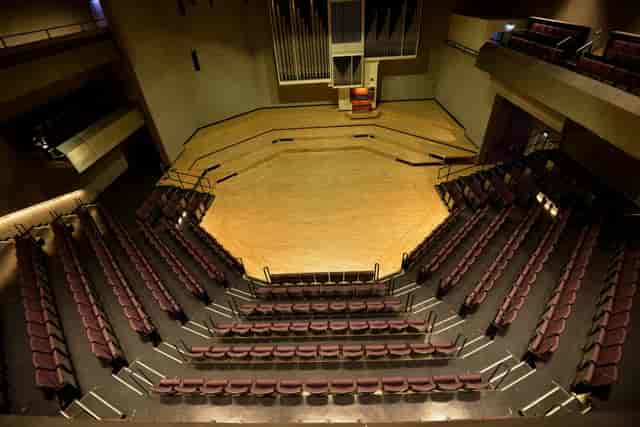 RNCM Concert Hall: Multi-tiered auditorium with central stage for lectures and panel discussions.