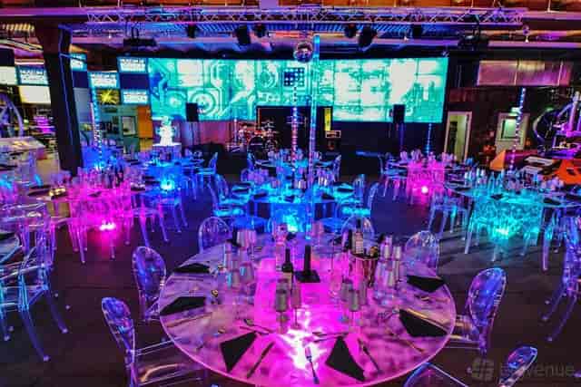 Corporate gala at Revolution Manchester Gallery with smart lighting and sleek ghost chairs.