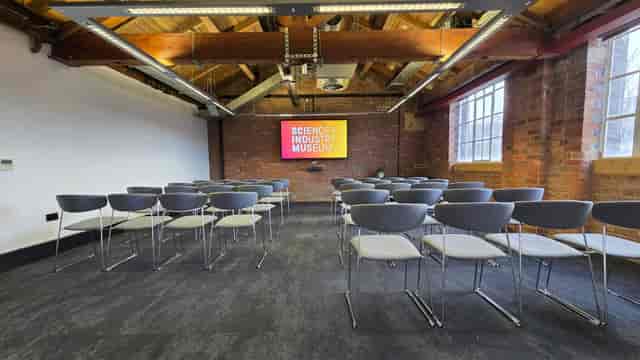 Industrial-chic Studio space with exposed brick for professional presentations and meetings.