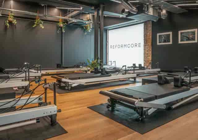 Reformer Pilates studio with industrial design for corporate wellness and team-building events.