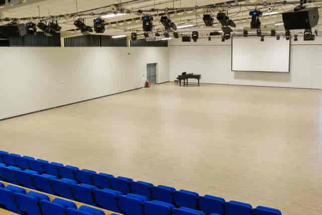 Johnson Centre Sports Hall with tiered seating for conferences and events.