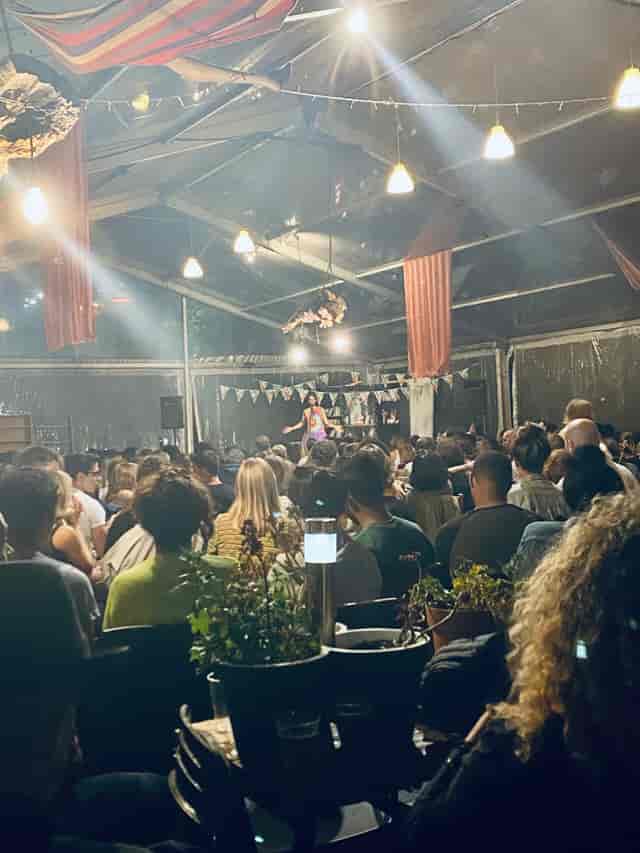 Theater-style seating at Fábrica Braço de Prata event venue with atmospheric lighting.