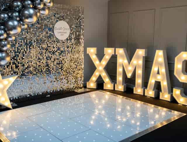 Sequin shimmer wall and LED marquee at Trowbridge Gallery holiday party event venue.