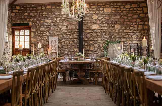 Rustic banquet tables at The Barn, Old Down Estate for upscale wedding receptions or private dinners.