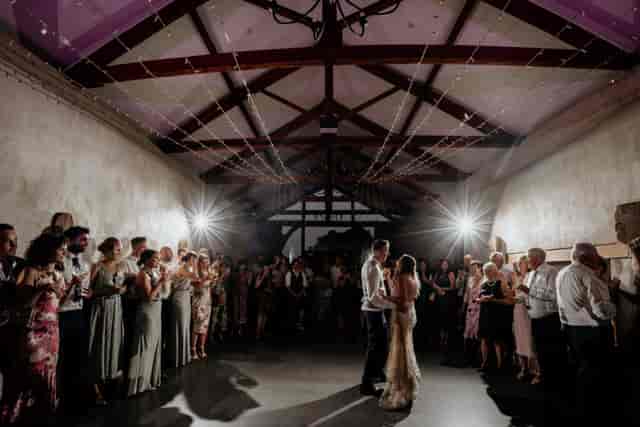 Rustic barn wedding venue at Ash Barton Estate with intimate bistro lighting for first dances.