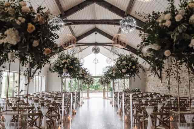 Yorkshire wedding barn ceremony space with elevated floral installations for luxury weddings.