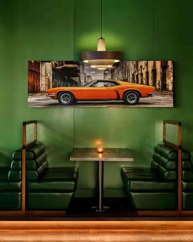 Industrial-chic breakout nook with high-backed banquettes for corporate networking and events.