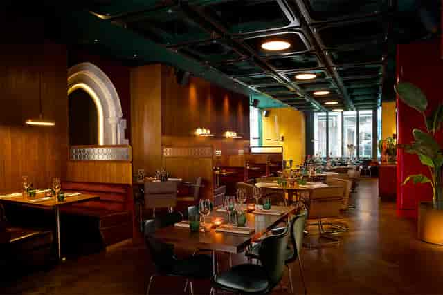 Sophisticated Motorino restaurant venue with booth seating for corporate dinners and mixers.