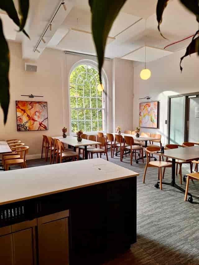 Sakura Cafe Woburn House: Light-filled meeting space with modular tables for workshops and meetings.