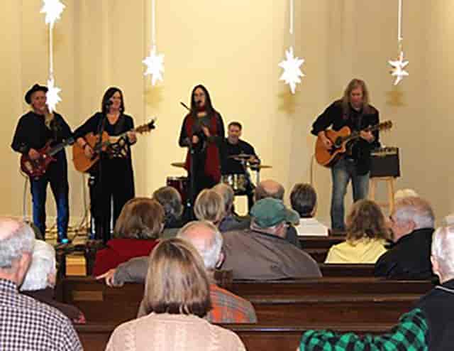 Acoustic performance in Christ Church Isle of Dogs with paper star decor for intimate events.