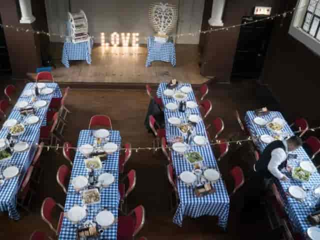 Rustic event hall setup with string lights at Harbinger Primary School for weddings and parties.