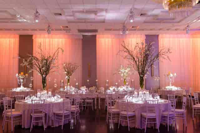 Golden Palms Ballroom with amber uplighting for elegant wedding receptions and formal dinners.
