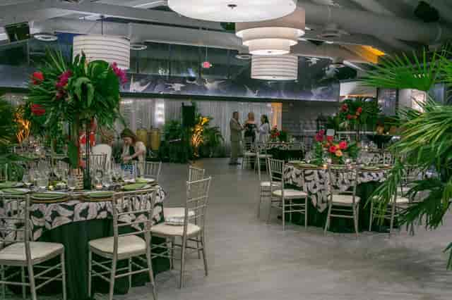 Tropical gala at Golden Palms Ballroom: elegant floral decor for luxury corporate event planning.