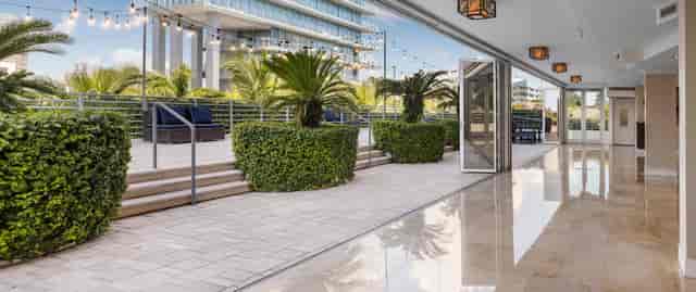Pool deck event space at Hilton Bentley Miami, featuring indoor-outdoor terrace for networking.