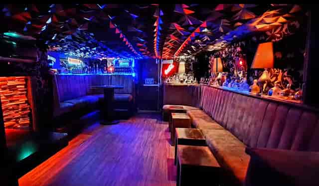 Intimate evening reception in The Penguin Room with perimeter banquette seating and ambient lighting.