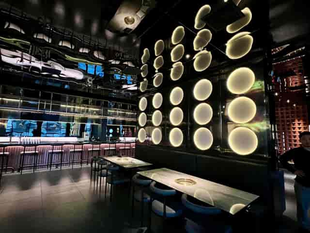 Contemporary restaurant venue with marble tables for cocktail receptions and networking events.