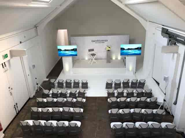Fireside chat stage at The Loft in Factory 251 with theater seating for corporate event venue.